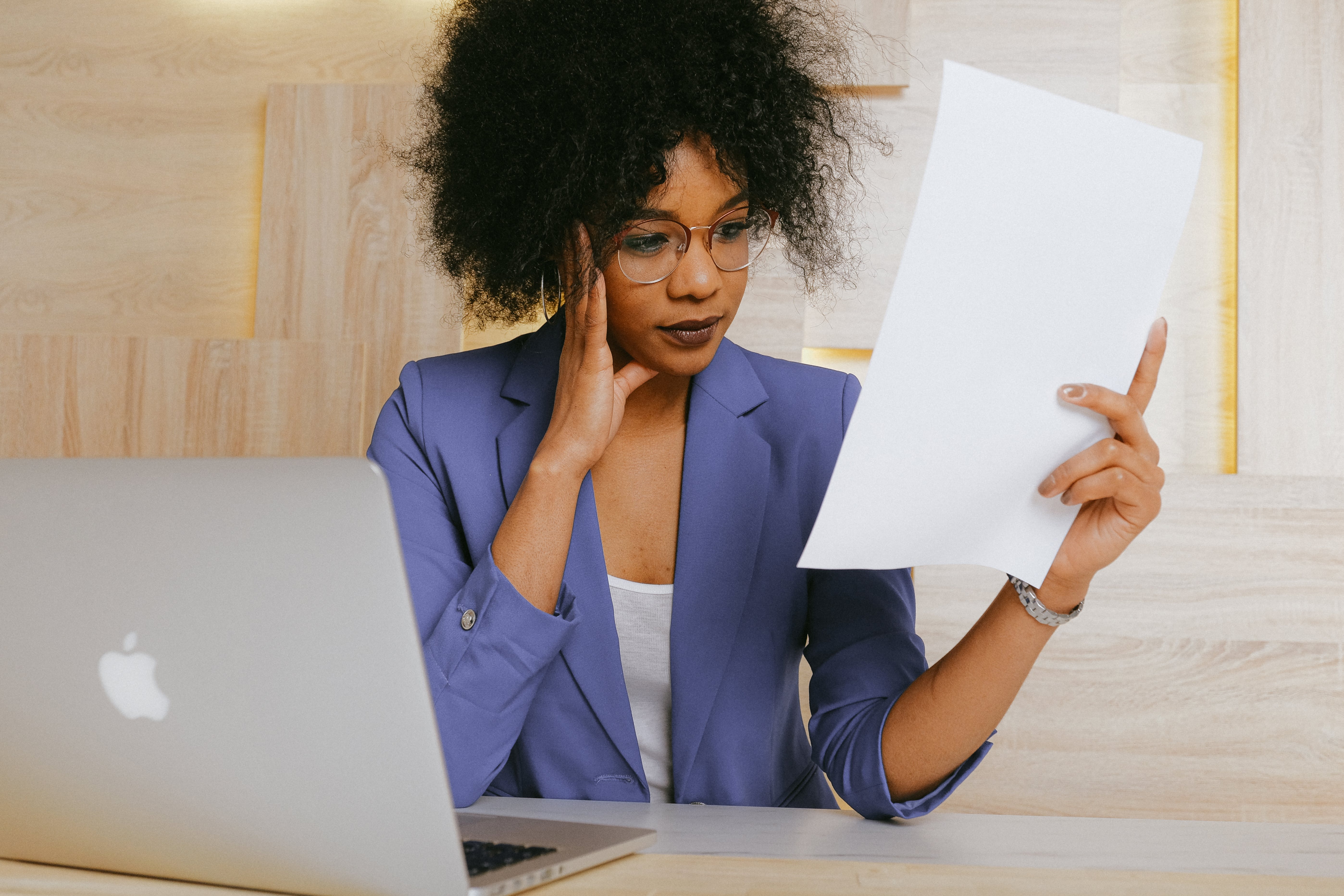A woman looks confused at some paperwork.